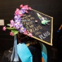 Image of a graduation cap reading "She turned her can'ts into cans and her dreams into plans. 