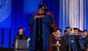 LaGarrett King hoods his PhD student Dawnavyn James. 