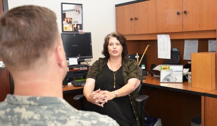 Counselor speaking with an army veteran. 