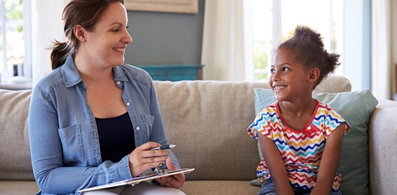 Woman counseling a young child. 