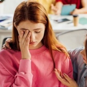 Friend consoling a student who is being bullied. 