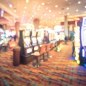 Abstract image of casino floor with slot machines. 