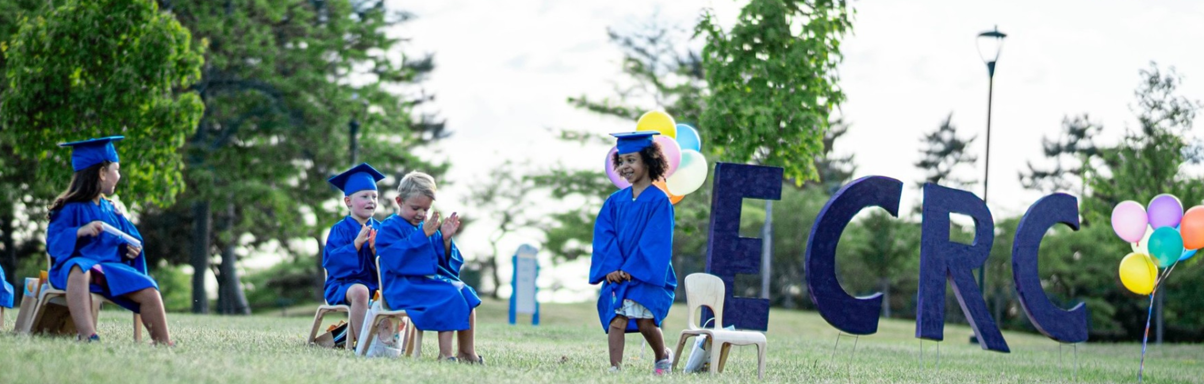 Early Childhood Research Center students standing on a hill at graduation. 