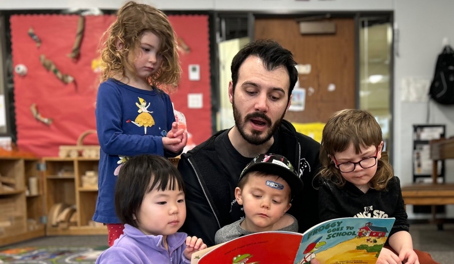Micheal Sheridan reading to students in the Early Childhood Research Center. 