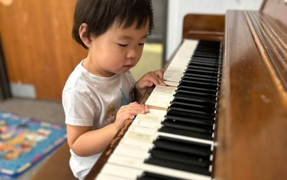 Child playing a piano. 