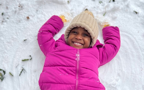 Student making a snow angel. 