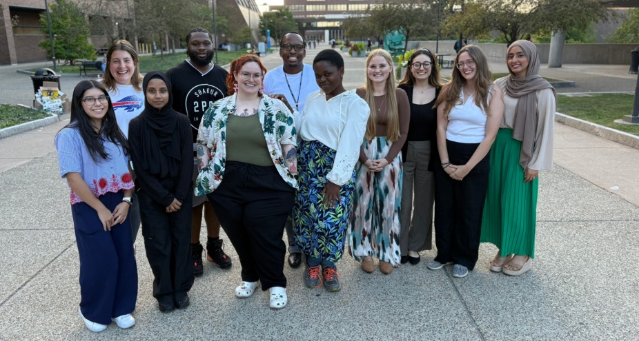 A group of master's level students posing for a photo. 