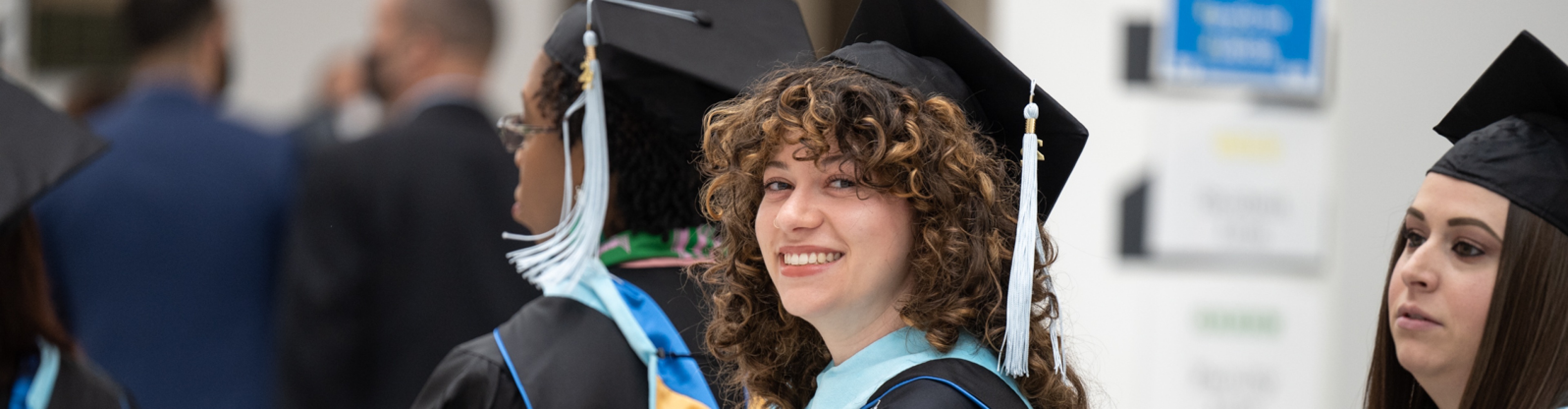 Image of students in caps and gowns. 