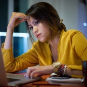 Young student studying at a computer. 