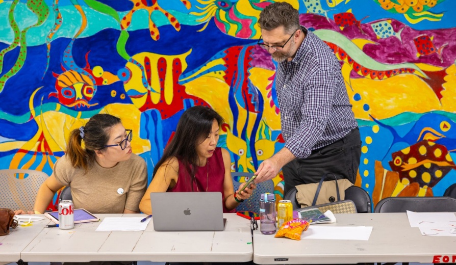 Chris Hoadley directing Christine Wang on educational technology.