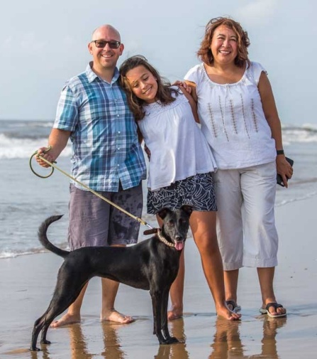 Zoom image: Martin, Maya, Flor, and their dog, Luna, at Pallavakkam Beach, near their former home in Chennai, India, where he taught at the American International School Chennai for six years. April 2018. (Photo/Melissa Freitas). 