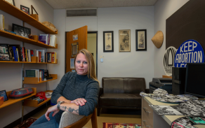 GSE Assistant Assistant Professor Melinda Lemke sitting in a chair in her office. 