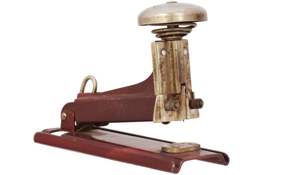Image of an antique stapler. 