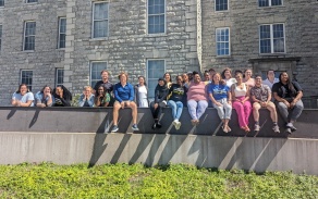 2023 teacher resident cohort pirctured outside Hayes Hall on South Campus. 