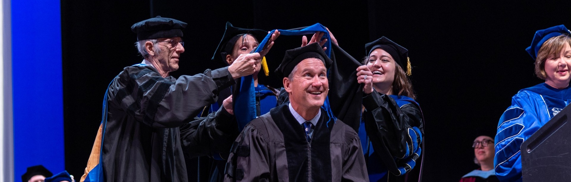 Image of faculty hooding a doctoral candidate at 2023 commencement ceremony. 