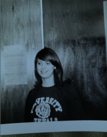 Nell Tyler, black and white photo. Wearing a University at Buffalo crew neck sweatshirt. 