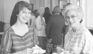 Nell standing with a mentor at a gathering. 