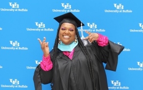 A GSE graduate in the CFA atrium followimg commencement. 