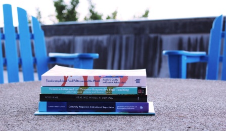 Stack of books published by GSE faculty. 