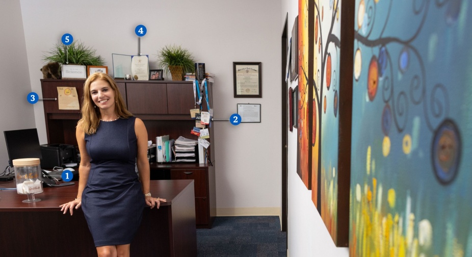 Zoom image: A portrait taken of Amanda Nickerson sitting in her north campus office. 