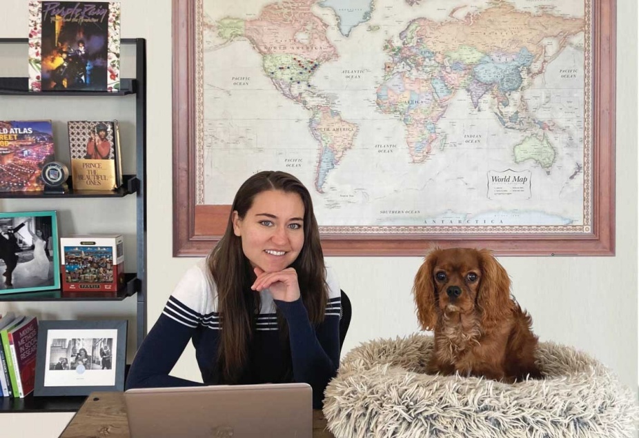 A portrait taken of Tiffany Karalis Noel sitting in her home office with her dog Dexter. 