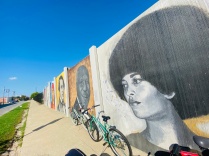 Zoom image: Bicycle near a wall of murals