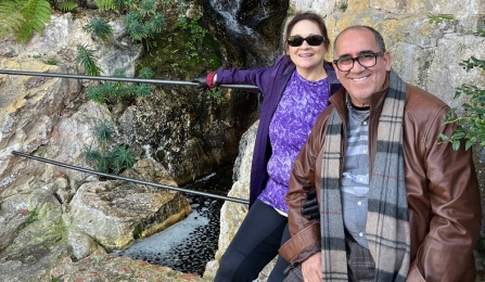 Cherif Sadki and his wife pose in front of waterfall and rocks. 