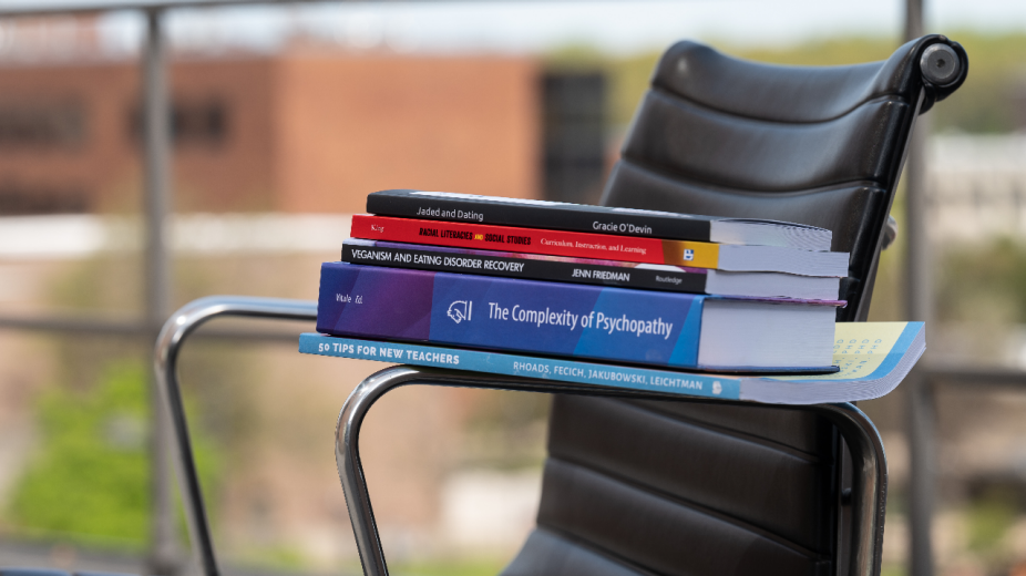 Stack of books on a railing. 