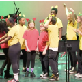 Zoom image: Students performing on stage at BAND Against Bullying event.