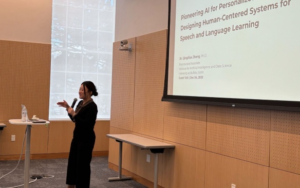 Three minute thesis check held by winning student.
