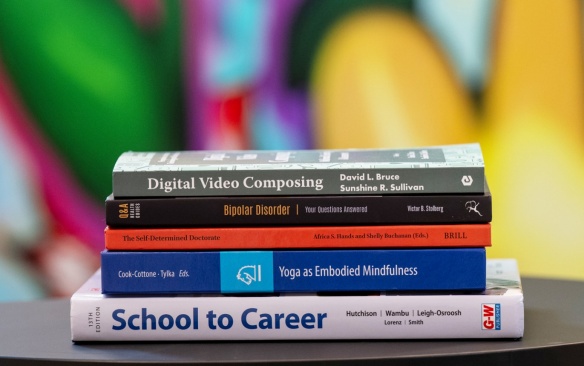 Stack of books published by GSE faculty. 