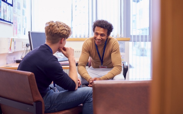A male counselor working with a patient in deep discussion. 