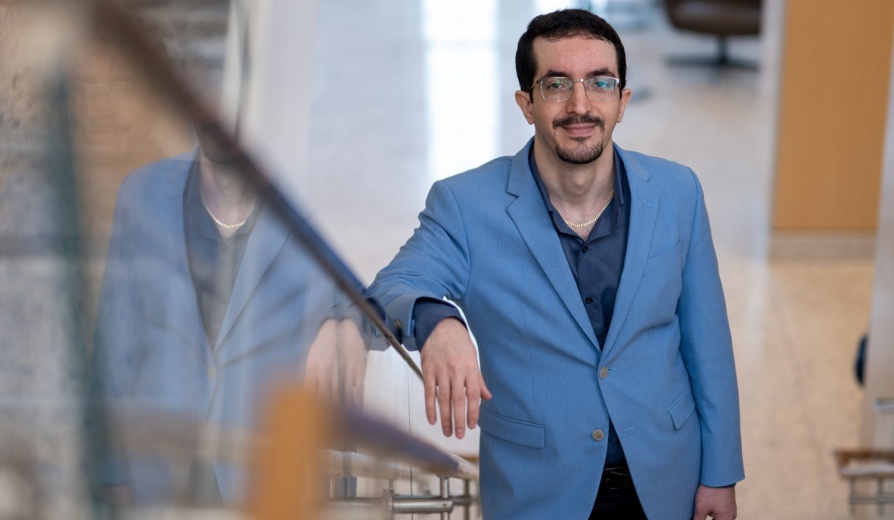 Reza Nahid Sahlan standing on a staircase. 
