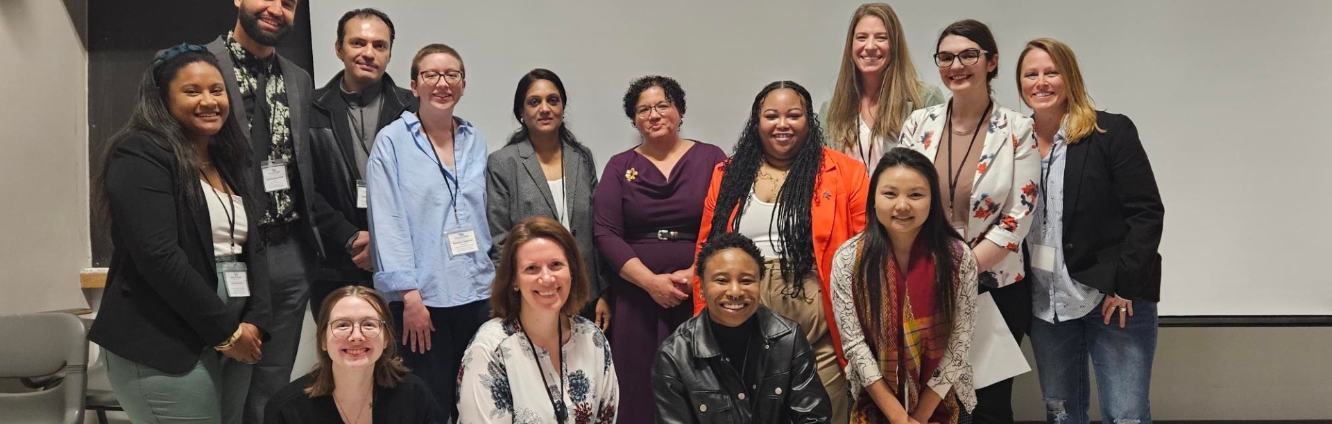 College students at symposium pose as a group. 