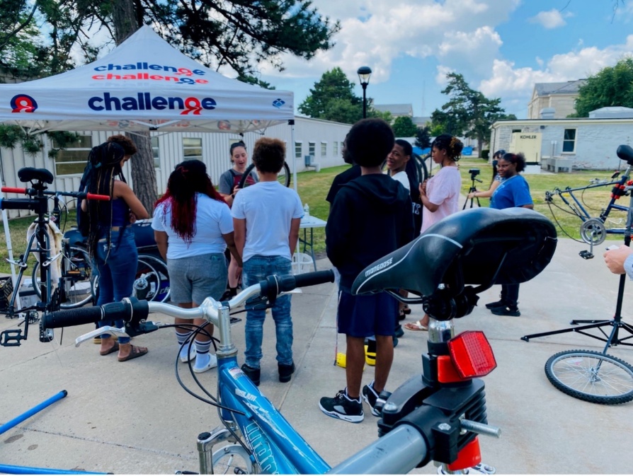 Zoom image: Children standing in line at a bicycle event. 