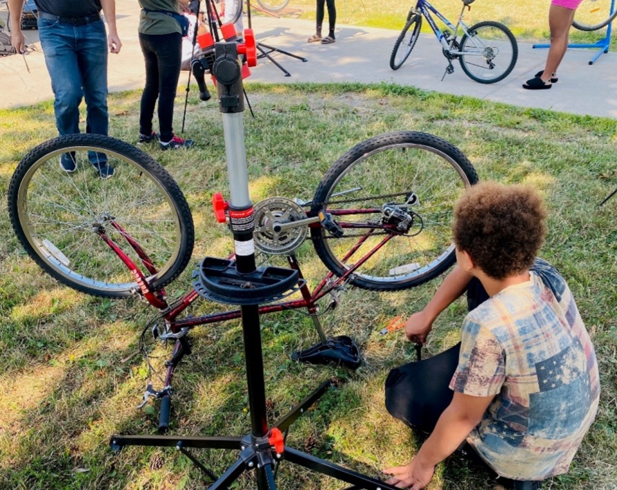 Youth cyclist repairing a bike. 