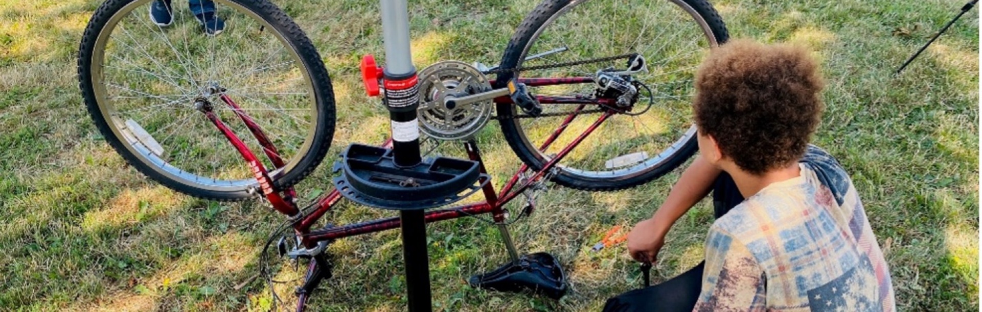 Youth bicyclist fixing a bicycle. 