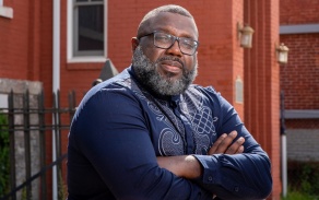 Portrait of LaGarrett King, a new professor in the Graduate School of Education, photographed with near the Michigan Street Baptist Church in downtown Buffalo, NY in September 2022. Photographer: Meredith Forrest Kulwicki. 