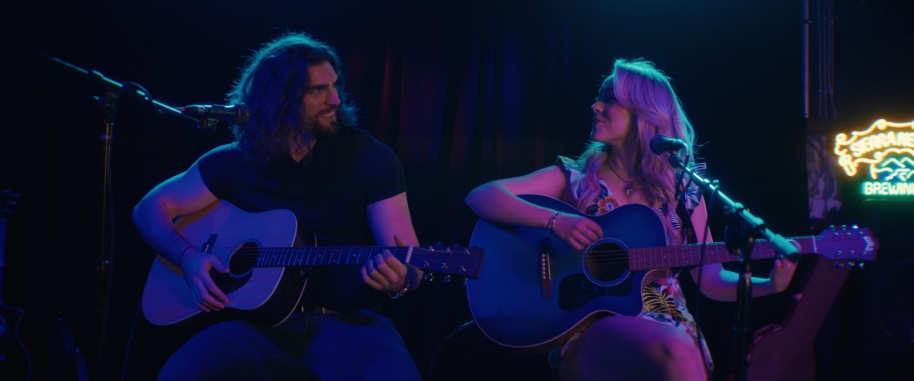 Joseph Veronica and Cami Clune playing guitar. 