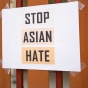 Sign taped to a fence stating "Stop Asian Hate.". 