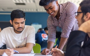 Diverse group of male students working together in Capen Hall. 