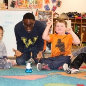 An excited Lochlan Schlader watches as the code-a-pillar With him are teacher Stanley Diih and Janice Leong and Griffin Maines. 