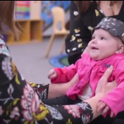 Infant with neuro activity monitor on forehead. 