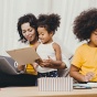 Mom working from home teaching two children. 