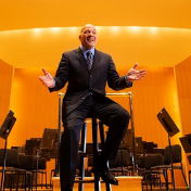 Chris Vasquez, GSE student on the stage of Kleinhans Music Hall. 