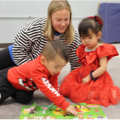 UB student playing with ECRC students in Fisher Price Play Lab. 
