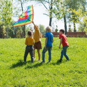 Kids flying a kite outside. 