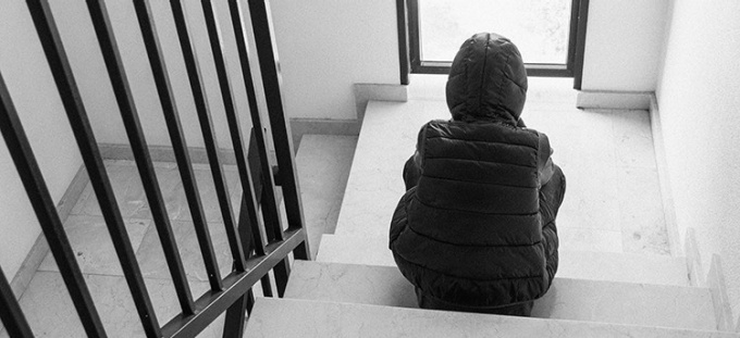 Child sitting in a stairwell.
