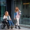 Woman with disability interacting with an able-bodied woman. 