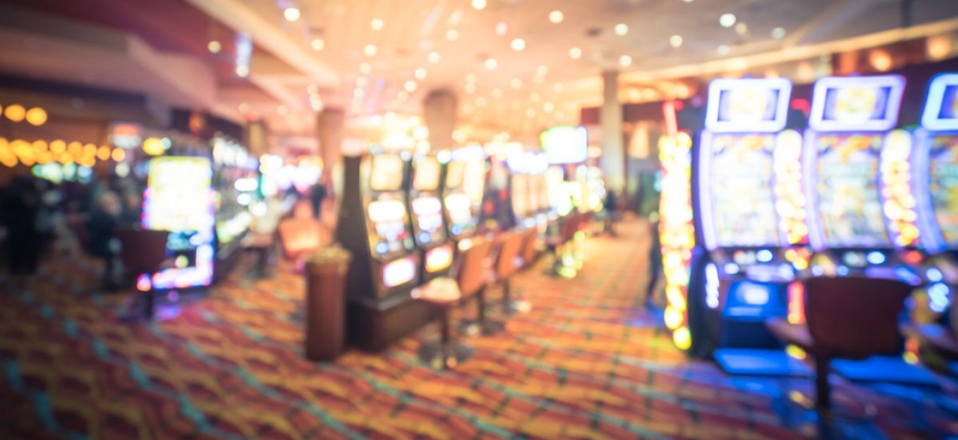 Room in a casino with multiple gambling machines. 
